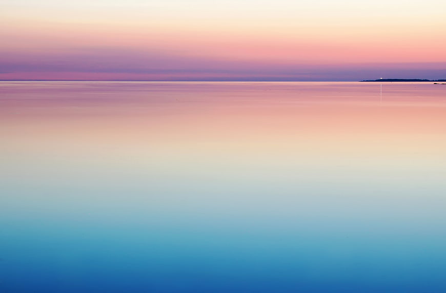 Minimalist pastel sunset seascape with smooth water gradient