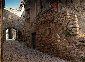 Medieval Stone Alleyway With Cobblestones And Arched Passage