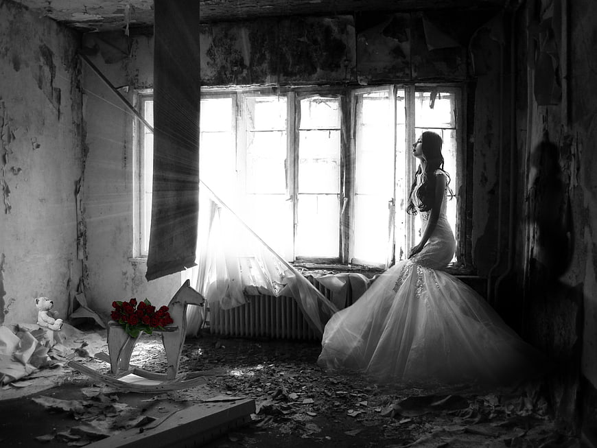 Bride in Ruined Room with Red Roses and Rocking Horse
