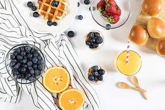Healthy breakfast flat lay with waffles, berries, and orange juice