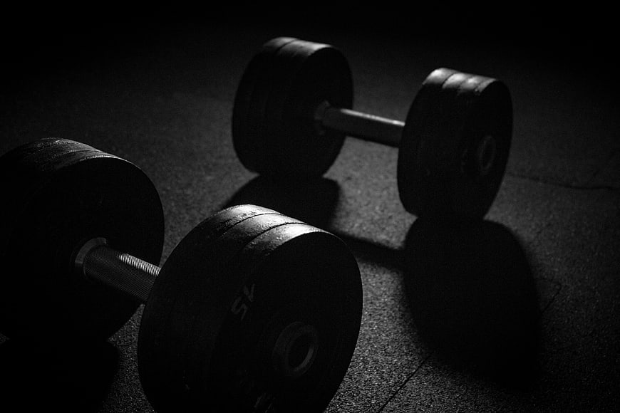 Dark Moody Dumbbells on Gym Floor