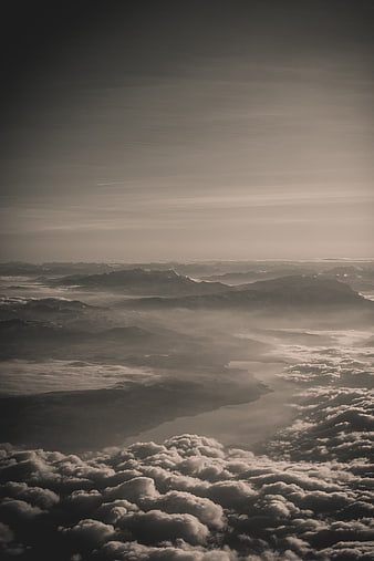 Aerial View of Mountains and Clouds in Sepia Tone