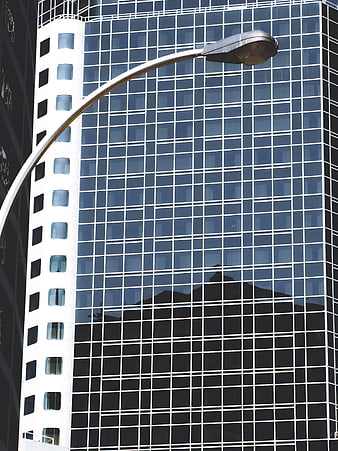 Modern Glass Skyscraper with Street Lamp Reflection