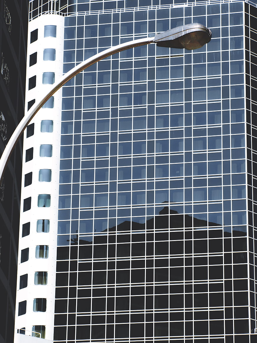 Modern Glass Skyscraper with Street Lamp Reflection