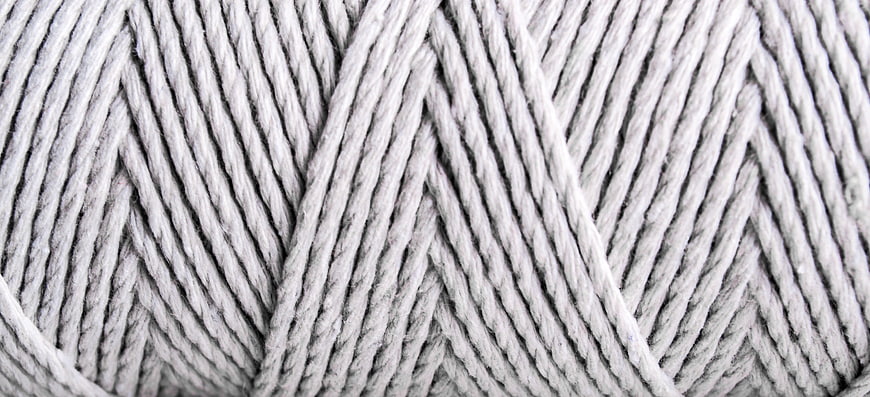 Close-up texture of white twisted cotton yarn fibers