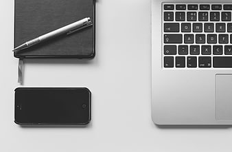 Minimalist Workspace with Laptop, Notebook, and Smartphone