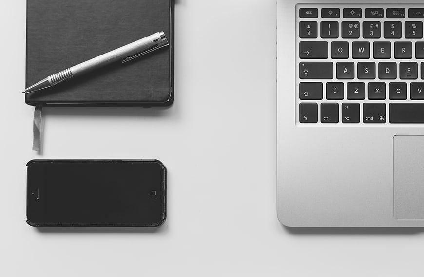 Minimalist Workspace with Laptop, Notebook, and Smartphone