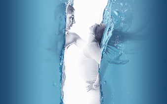 Underwater couple embracing in blue water with light