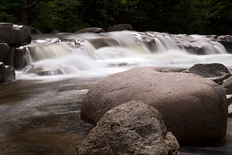 Long Exposure River Rapids Flowing Over Rocks