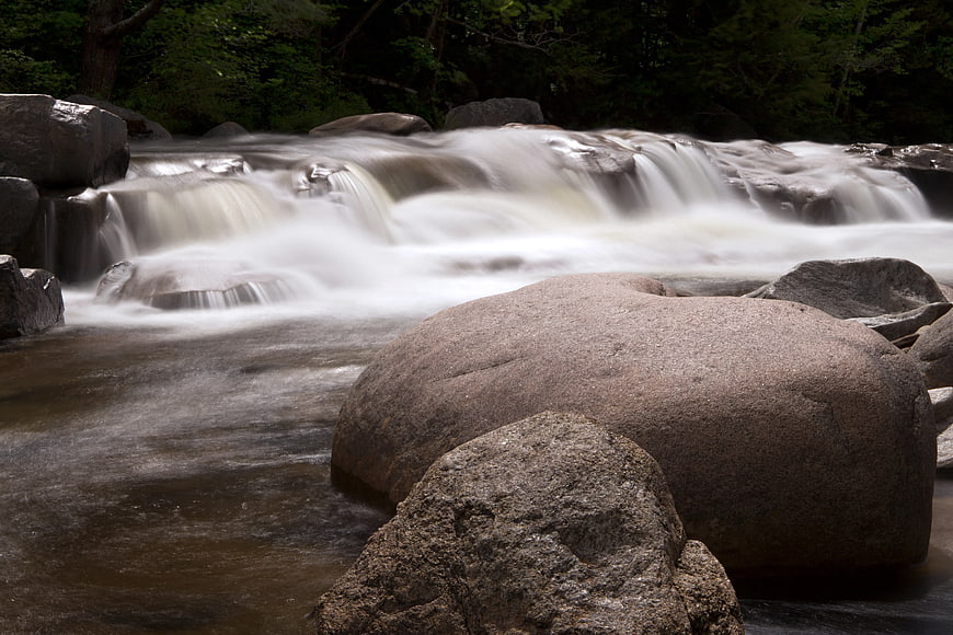 Long Exposure River Rapids Flowing Over Rocks
