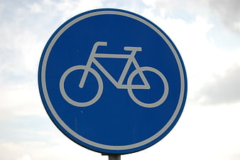 Blue Bicycle Traffic Sign Against Cloudy Sky