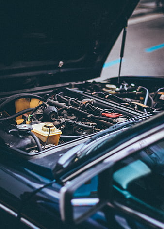 Close-up of car engine bay with hood open
