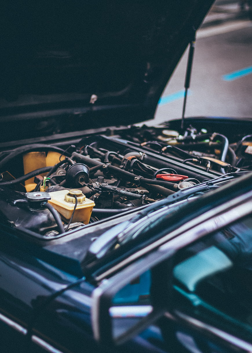 Close-up of car engine bay with hood open