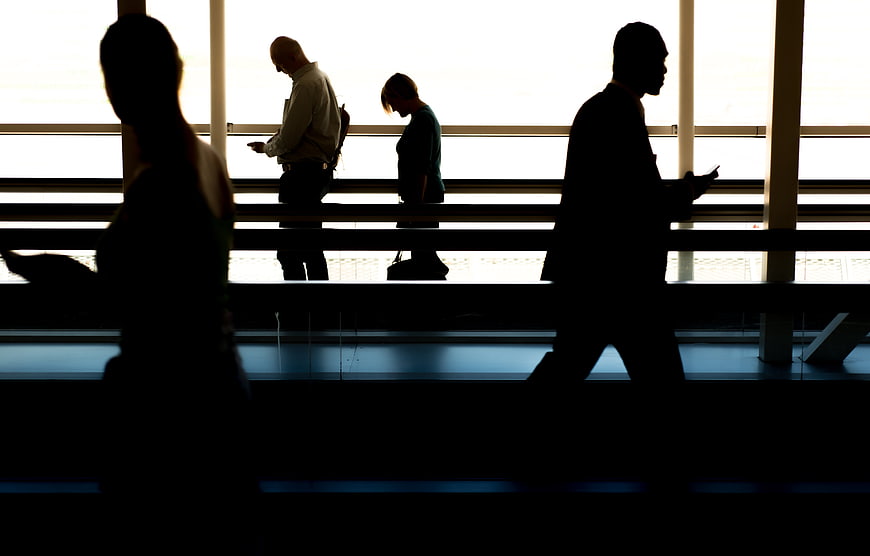 Silhouettes of business people walking in airport terminal