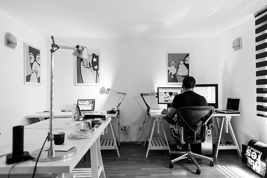 Man working at computer in modern black and white office