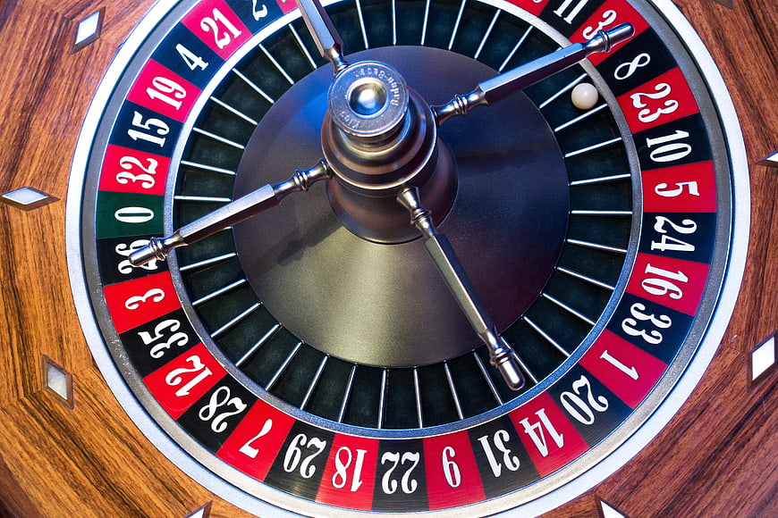 Close-up of a spinning roulette wheel with white ball