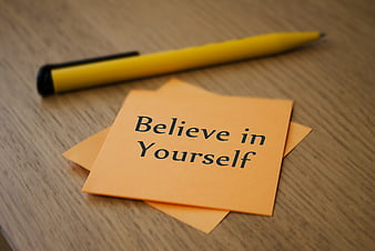 Believe in Yourself Sticky Note on Wooden Desk