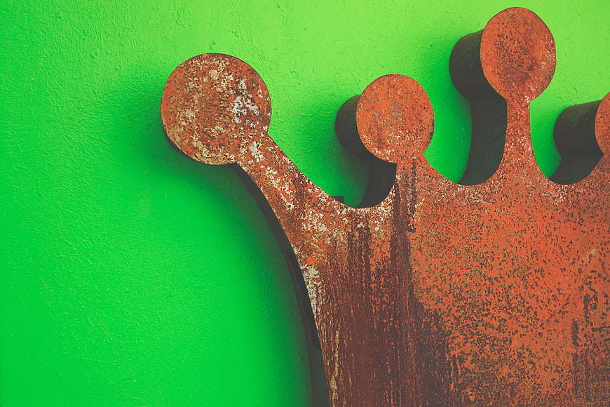 Rusty Metal Crown on Bright Green Wall