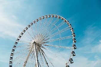 White Ferris Wheel Against Blue Sky