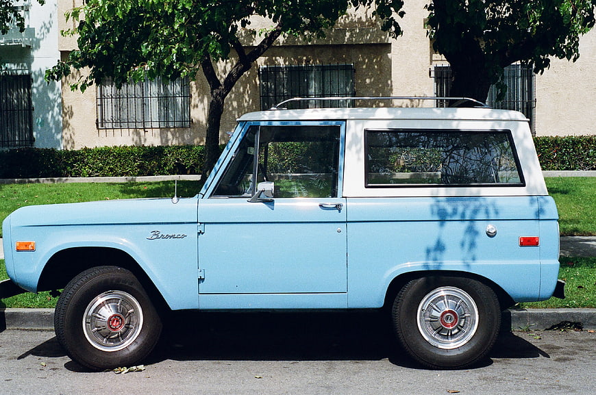 Vintage Light Blue Ford Bronco SUV Parked on Street