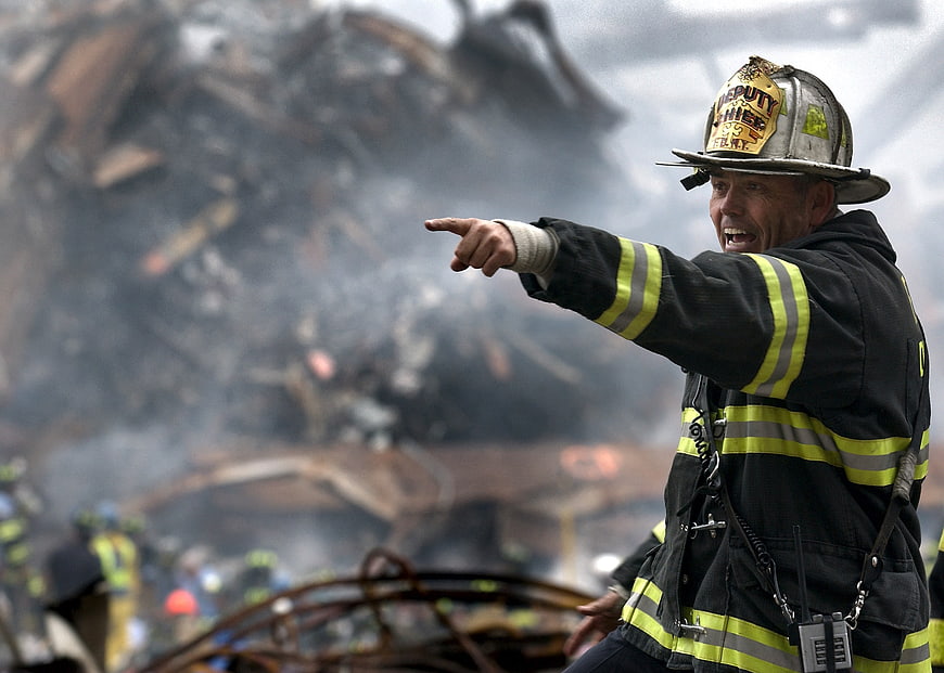 Firefighter Deputy Chief Pointing at Rubble