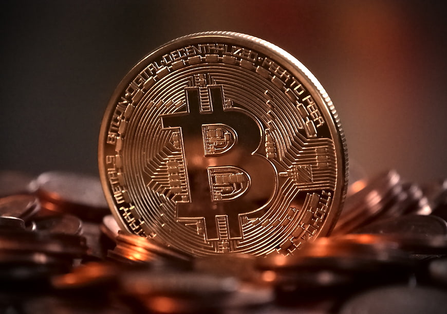 Golden Bitcoin Coin on Pile of Cryptocurrency