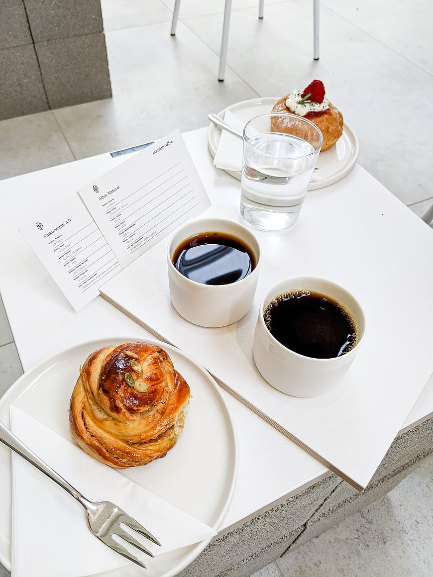 Minimalist coffee and pastry breakfast on white table