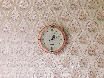 Vintage Pink Wall Clock on Floral Wallpaper