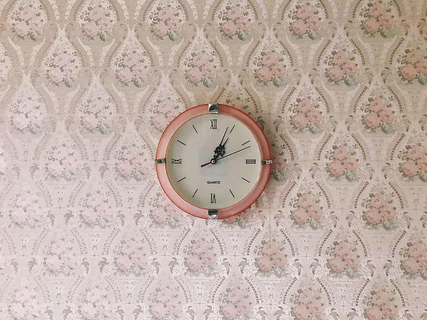 Vintage Pink Wall Clock on Floral Wallpaper
