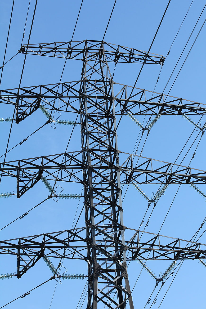 High Voltage Power Line Tower Against Blue Sky