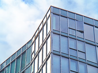 Modern Glass Office Building Facade Against Blue Sky