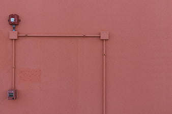 Minimalist Fire Alarm Box On Textured Pink Stucco Wall
