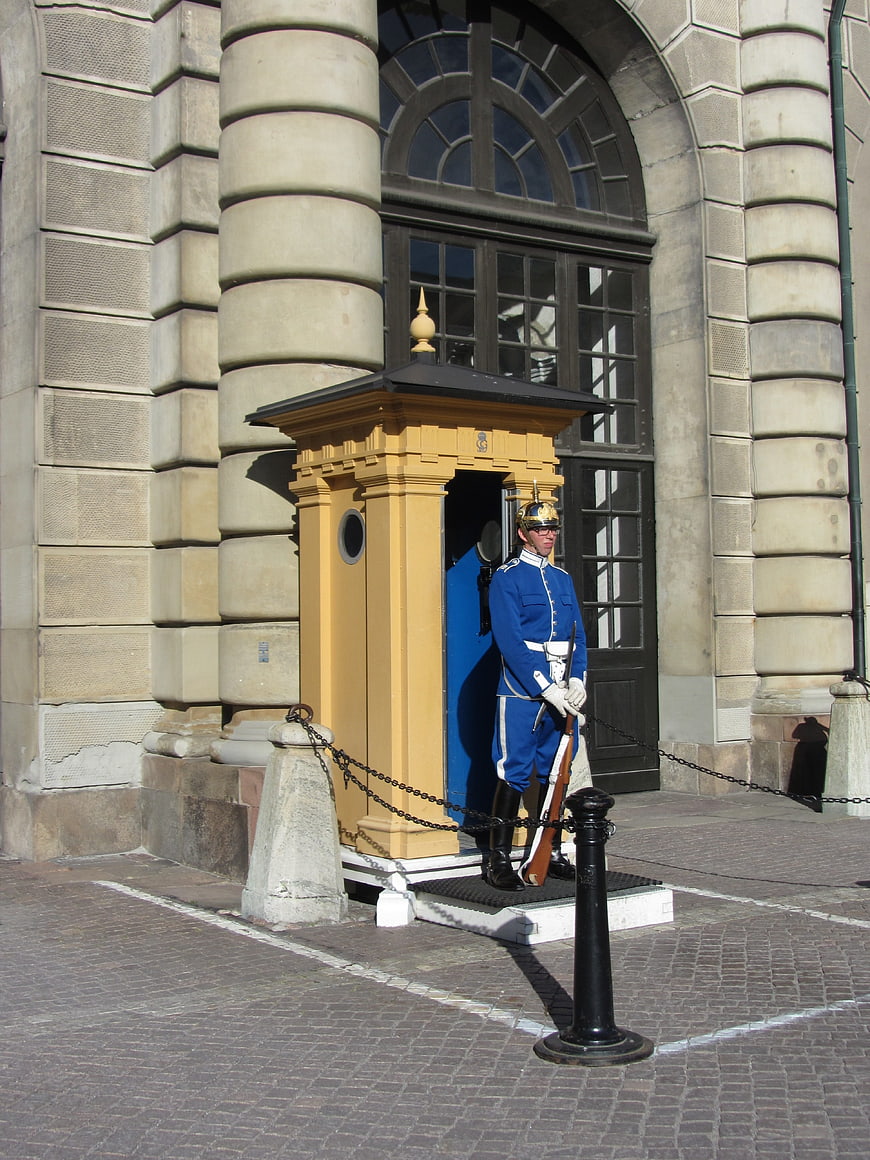 Royal Guard Standing At Yellow Sentry Box In Stockholm