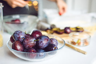 Fresh plums in glass bowl ready for baking