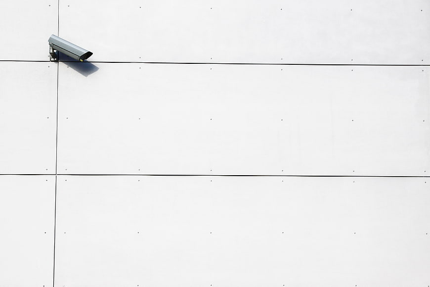 Minimalist Security Camera on White Wall