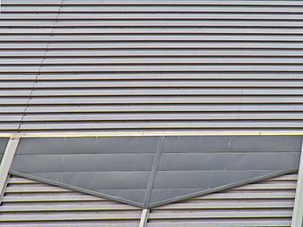 Abstract gray corrugated metal wall texture with geometric panel