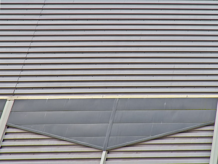 Abstract gray corrugated metal wall texture with geometric panel