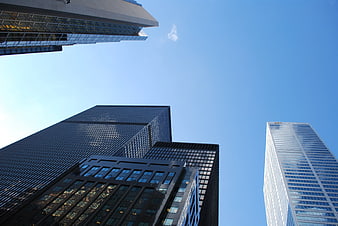 Worms eye view of modern skyscrapers against blue sky