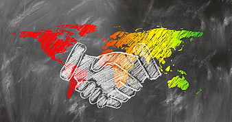 Chalkboard drawing of handshake over world map