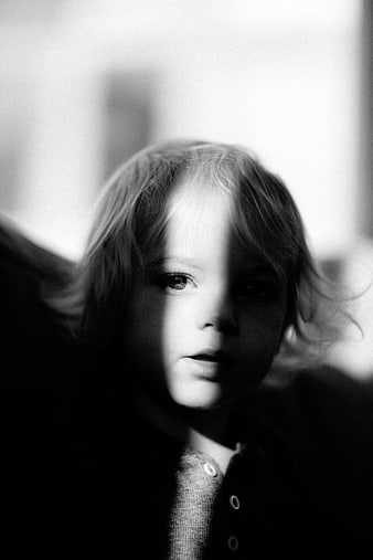 Black and white portrait of a child with dramatic lighting