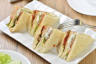 Club Sandwiches with Lettuce and Tomato on White Plate