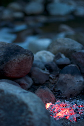Glowing Campfire Embers Surrounded by River Stones