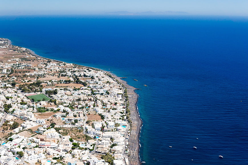 Aerial View of White Coastal Town and Blue Sea