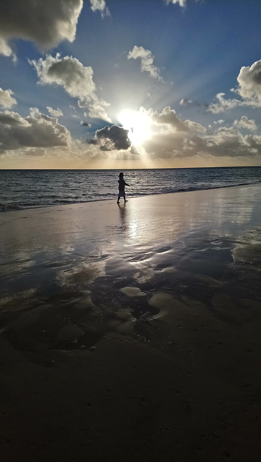 Silhouette of Child Walking on Beach at Sunset