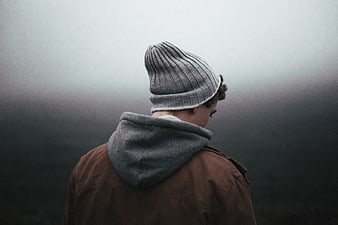 Man in Beanie and Jacket Looking into Foggy Landscape