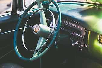 Vintage Green Car Interior with Steering Wheel and Dashboard