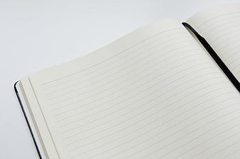 Open Blank Lined Notebook With Black Ribbon Bookmark On White Surface