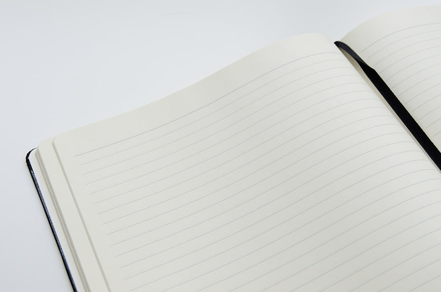 Open Blank Lined Notebook With Black Ribbon Bookmark On White Surface