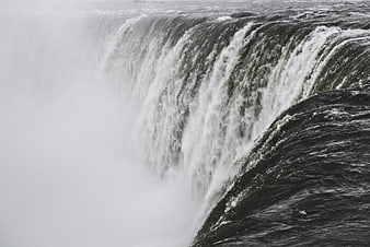 Powerful waterfall cascading into misty spray