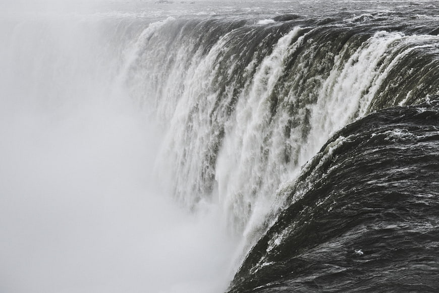 Powerful waterfall cascading into misty spray